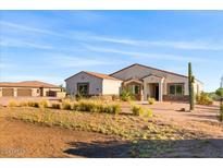 Single-story home with stone accents and desert landscaping at 1623 E Hidalgo St, Apache Junction, AZ 85119