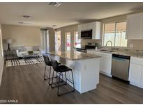 Bright kitchen with stainless steel appliances, granite countertops, and an island with bar stool seating at 205 S Higley Rd # 4, Mesa, AZ 85206