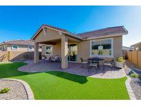 Covered patio with artificial turf and seating area at 24862 N 172Nd Ave, Surprise, AZ 85387