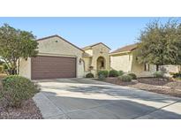 Single story home with brown garage door and landscaped yard at 26463 W Sierra Pinta Dr, Buckeye, AZ 85396