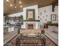 Elegant living room with a cozy fireplace and comfortable seating at 35602 N Screaming Eagle Pass, Cave Creek, AZ 85331
