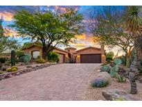 Stunning desert landscape surrounds this beautiful home, featuring a large driveway and 3-car garage at 36578 N Boulder View Dr, Scottsdale, AZ 85262