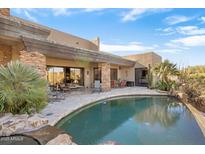 Luxury backyard oasis featuring a large pool, spacious patio, and stunning mountain views at 39816 N 106Th Pl, Scottsdale, AZ 85262