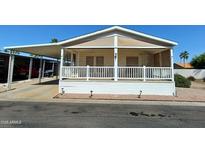 Single-wide manufactured home with covered porch and carport at 9333 E University Dr # 196, Mesa, AZ 85207