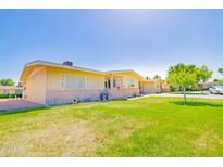 Ranch style home with carport and well-manicured lawn at 10317 W Corte Del Sol Este --, Sun City, AZ 85351