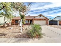 Brick ranch home with a landscaped yard and a two-car garage at 1715 N Silverado --, Mesa, AZ 85205