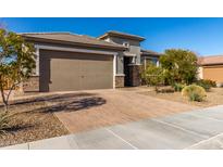 Single-story home with a two-car garage and desert landscaping at 21778 N 259Th Ln, Buckeye, AZ 85396
