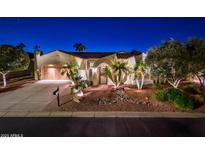 Beautiful Spanish style home with lush landscaping at night at 23206 N Del Monte Dr, Sun City West, AZ 85375