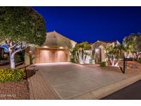 Luxury home with driveway and landscaped front yard at night at 23206 N Del Monte Dr, Sun City West, AZ 85375
