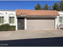 Front view of a Spanish-style home with a two-car garage and a terracotta tile roof at 3401 N 37Th St # 14, Phoenix, AZ 85018