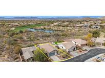 A lovely exterior aerial view of a home with a manicured lawn, landscaping, and mountain views at 41512 N Tangle Ridge Ct, Anthem, AZ 85086