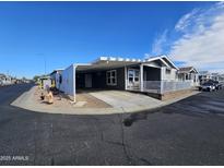 Single-level home with carport and landscaped yard at 650 N Hawes Rd # 3702, Mesa, AZ 85207