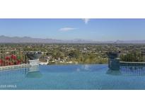 Stunning infinity pool overlooks a panoramic mountain and city vista at 7150 N 64Th Pl, Paradise Valley, AZ 85253