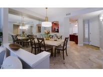 Bright dining room features a large table, seating for six, and a view into the kitchen at 10017 E Mountain View Rd # 1087, Scottsdale, AZ 85258