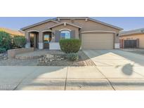 One-story house with a two-car garage and landscaped front yard at 1113 W Fir Tree Rd, Queen Creek, AZ 85140