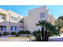 Tan stucco building with palm trees and walkway at 11333 N 92Nd St # 2094, Scottsdale, AZ 85260