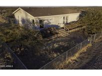 Aerial view of a ranch-style home with fenced yard and desert landscape at 12866 W Sun Ave, Eloy, AZ 85131