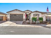 Single-story home with a two-car garage and landscaping at 17255 W Seldon Ln, Waddell, AZ 85355