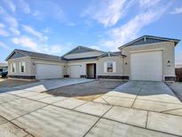 New construction home with 3-car garage and desert landscaping at 18149 W Georgia Ct, Litchfield Park, AZ 85340