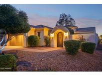 Stunning Spanish-style home with arched entryway and landscaped yard at 22728 N Arrellaga Dr, Sun City West, AZ 85375