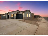 Charming single-story home with a two-car garage and stone accents on the facade at 2685 E Santa Ynez Dr, Casa Grande, AZ 85194
