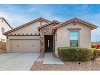 One-story home with stone accents and a two-car garage at 29715 N 119Th Ln, Peoria, AZ 85383