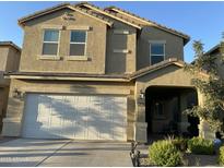 Two-story house with a white garage door and landscaping at 35262 W San Ildefanso Ave, Maricopa, AZ 85138