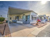 Inviting manufactured home exterior with covered carport and landscaping at 7750 E Broadway Rd # 510, Mesa, AZ 85208