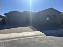 Single-story home with two-car garage and desert landscaping at 11011 E Texas Ave, Mesa, AZ 85212