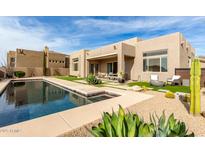 Luxury backyard oasis featuring a sparkling pool, spa, and inviting patio area at 11065 E Mark Ln, Scottsdale, AZ 85262