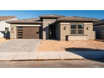 Single-story home with brown garage door and light brown brick exterior at 1364 E Nolan Pl, Chandler, AZ 85249