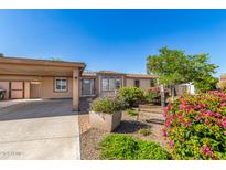 Tan house exterior with covered parking and landscaping at 1502 E Angela Dr, Phoenix, AZ 85022