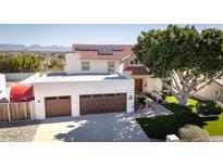 Two-story house with solar panels, two-car garage, and landscaped yard at 15021 N 19Th Way, Phoenix, AZ 85022