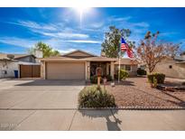 Ranch-style home with a two-car garage and landscaped front yard at 1511 W El Monte Pl, Chandler, AZ 85224