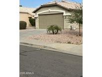 Single-story house with attached garage and desert landscaping at 15350 W Mauna Loa Ln, Surprise, AZ 85379