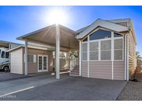 Tan colored manufactured home with covered patio and RV parking at 17200 W Bell Rd # 899, Surprise, AZ 85374