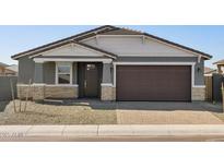 Charming single-Gathering home with a two-car garage and low-maintenance desert landscaping at 17755 W Elm St, Goodyear, AZ 85395