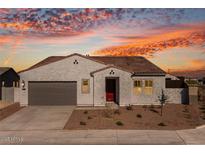 One-story home with gray stucco, brown roof, and a two-car garage at 18104 W Silverwood Dr, Goodyear, AZ 85338