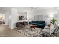 Bright living room with teal sofa and mid-century modern accents at 1913 E Sandra Ter, Phoenix, AZ 85022