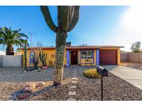 Cute yellow house with purple accents and a landscaped front yard at 2235 W Villa Rita Dr, Phoenix, AZ 85023