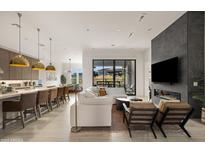 Open living room with modern fireplace and kitchen views at 23491 N 125Th Pl, Scottsdale, AZ 85255