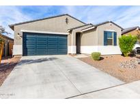 Single-story home with a two-car garage and landscaped front yard at 25412 N 144Th Dr, Surprise, AZ 85387