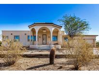 Spanish style home with arched entryway and two-car garage at 27511 N 33Rd Ave, Phoenix, AZ 85083