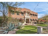 Brick building exterior with landscaping and a walkway at 304 W Roosevelt St # 102, Phoenix, AZ 85003