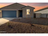 Charming single-story home featuring a well-maintained yard, blue garage door, and desert landscaping at 3403 E Audrey Dr, San Tan Valley, AZ 85143