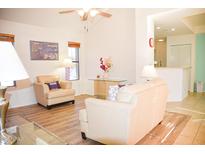 Bright living room with light beige couches and wood-look floors at 4201 N 20Th St # 205, Phoenix, AZ 85016