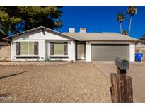 Charming single story home with gray garage door and well-maintained landscaping at 4316 E La Puente Ave, Phoenix, AZ 85044