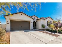 Single-story home with brown garage door and landscaping at 4415 N Sidney St, Buckeye, AZ 85396