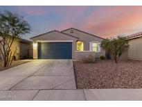 New construction home with two-car garage and landscaped yard at 5644 W Jackalope Ln, Laveen, AZ 85339