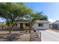 Cute single story home with a spacious front yard and chain link fence at 899 E Flint St, Chandler, AZ 85225